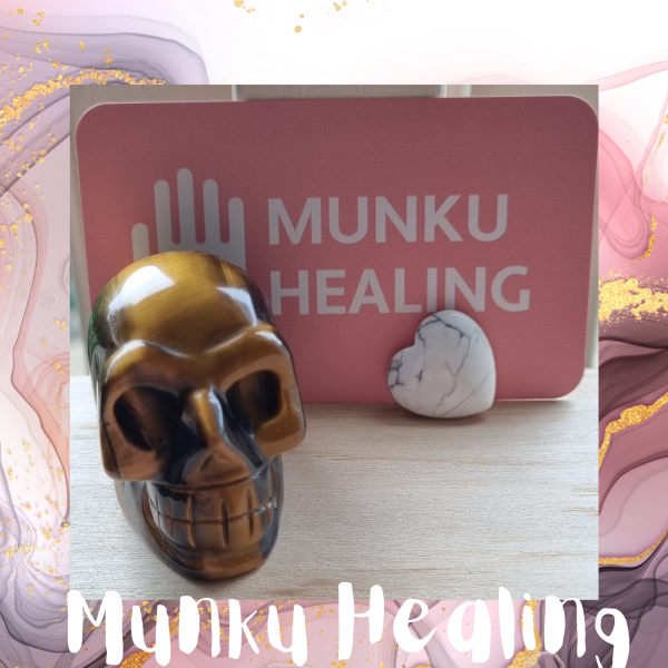Image of Tigers Eye Crystal Skull Carving, a protective stone known for aiding in goal accomplishment. Perfect for desk placement for daily guidance and support